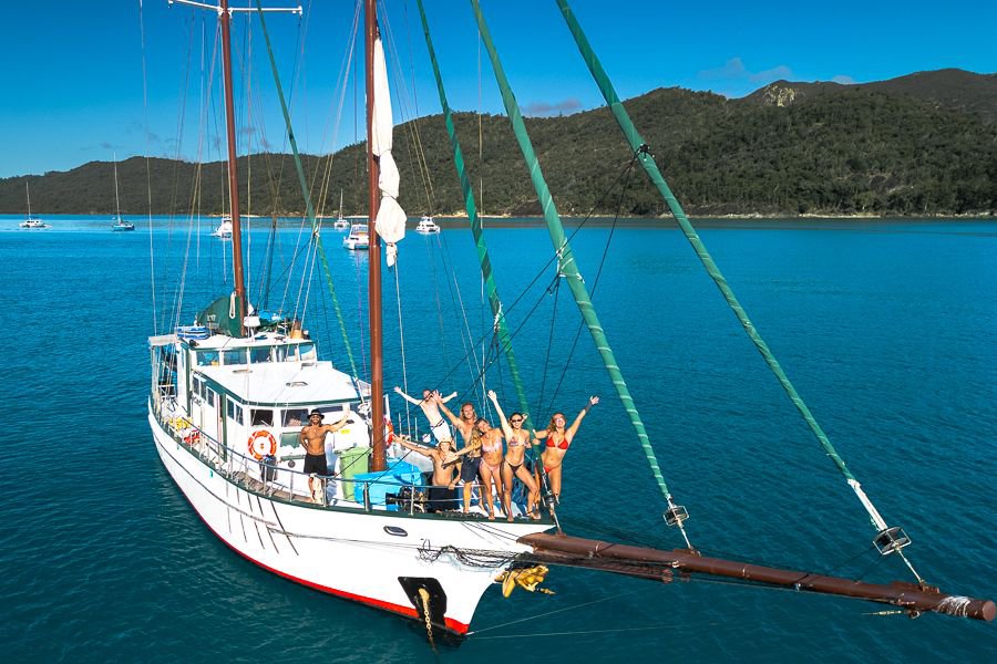 Group of guests posing at the bow of New Horizon in the Whitsundays