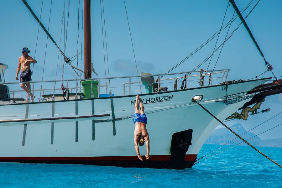 Guest diving into the ocean from New Horizon in the Whitsundays
