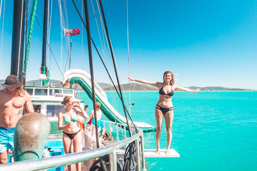 Guest about to jump in to the turquoise waters from New Horizon in the Whitsundays