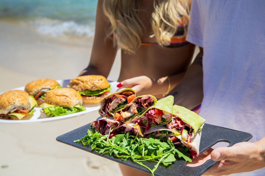 Fresh gourmet wraps and burgers served on the beach during a Whitsundays sailing tour, Queensland, Australia.