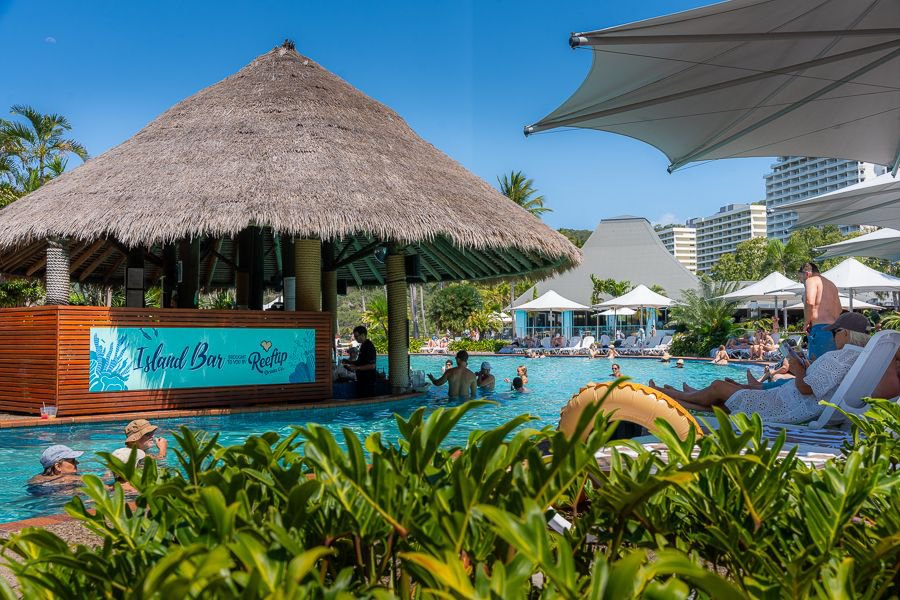 Guests relaxing at a tropical island resort pool bar in the Whitsundays