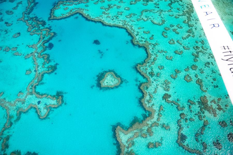 Aerial view of Heart Reef surrounded by turquoise waters and coral formations in the Great Barrier Reef.
