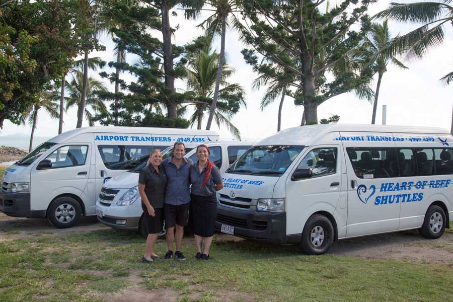 Heart of Reef Shuttles airport transfer vehicles parked in the Whitsundays with staff standing in front