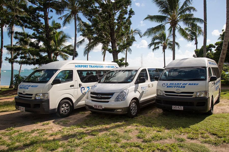 Heart of Reef Shuttles airport transfer vehicles parked near the waterfront in the Whitsundays