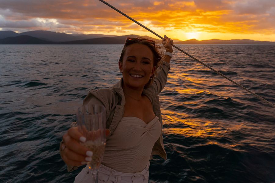 Whitsundays sunset cruise, champagne sailing Australia, Whitsunday Islands holiday, Airlie Beach boat tour, romantic sailing experience, Great Barrier Reef sunset, luxury yacht Whitsundays, Queensland island getaway, sunset drinks at sea, tropical sailing adventure