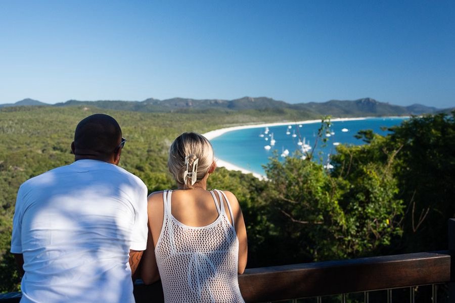 couple admiring the views at south whitehaven lookout in the whitsundays