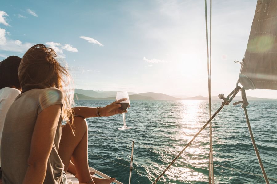 guests enjoying a drink on the deck of Blizzard Sailing yacht in the Whitsundays at sunset