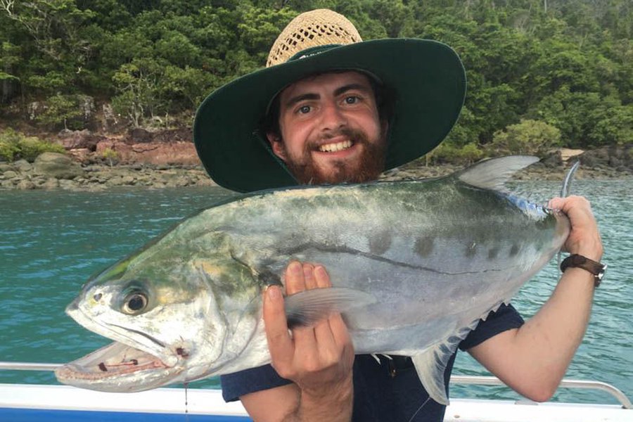 Man holding up a fish on a Whitsundays Fishing Charter