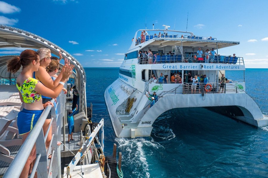 guests on Cruise Whitsundays reefworld pontoon watching ferry sail away over Great Barrier reef