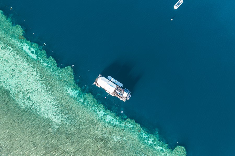 Aerial view of cruise whitsundays reefworld pontoon next to the great barrier reef in the whitsundays