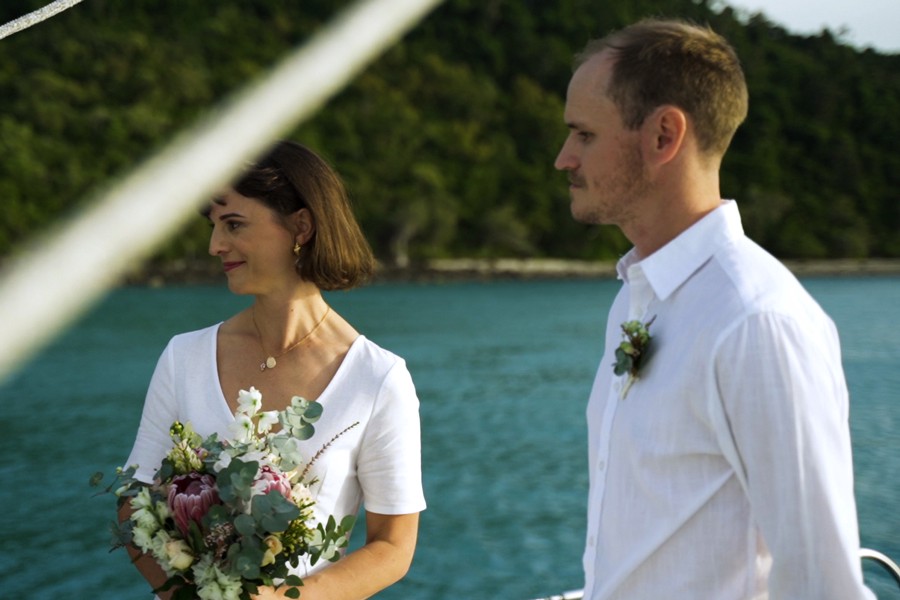 couple in wedding attire during a wedding ceremony on a whitsunday private charter